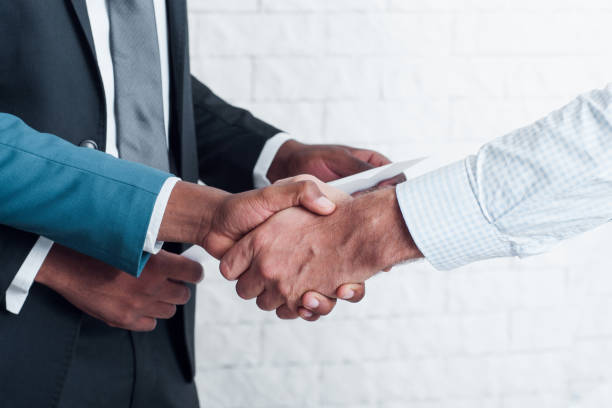 istock Partners handshaking after sign business contract 672123560