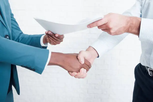 Photo of Shaking hands after signing business contract