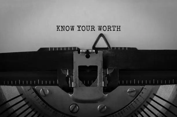 Photo of Text Know Your Worth typed on retro typewriter
