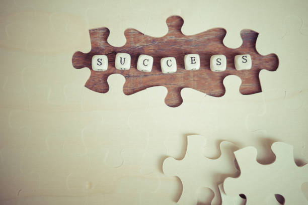 Word text "SUCCESS" on missing pieces of jigsaw puzzle, business concept. stock photo