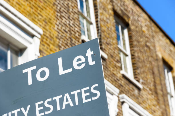 To Let property agency sign posted outside English terraced houses in Poplar, East London stock photo