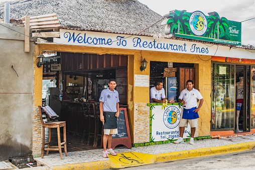 San Juan Del Sur: Staff from Restaurant Ines is waiting for customers. Restaurant is located on main street and backing into the beach in San Juan del Sur in Nicaragua.