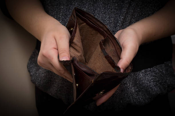 istock Old empty wallet in the hands of women. Poverty concept. 672137428