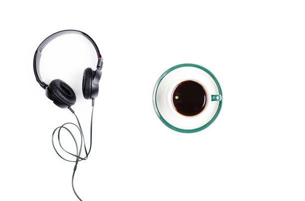 istock Headphones with mug of coffee on a white background. 672139932