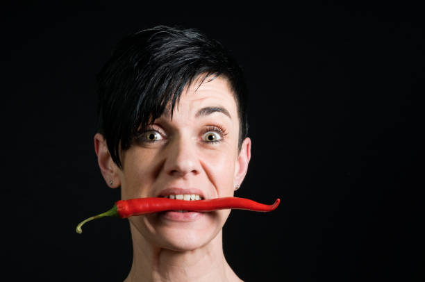 hot chilli in the mouth stock photo