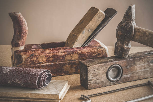istock Carpenter's old tools on the table in the workshop. Precise and attentive work. Vintage style. 672140356