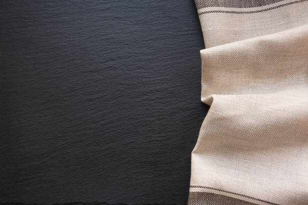 istock Rustic  linen napkin and black slate dish with copy space for your menu or recipe. Menu card for restaurants. 672140380