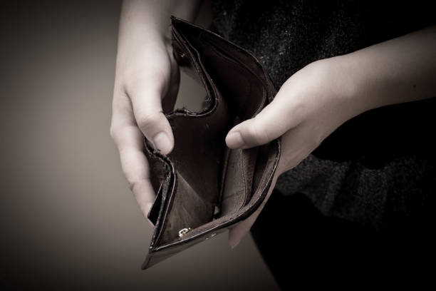 istock Old empty wallet in the hands of women. Poverty concept. 672143354