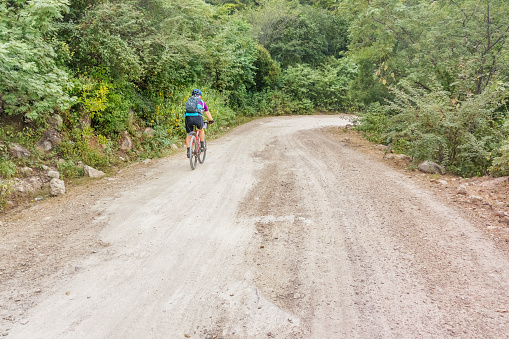 Yuscaran: Man is riding bicycle on the dirt road near Yuscaran in Honduras.