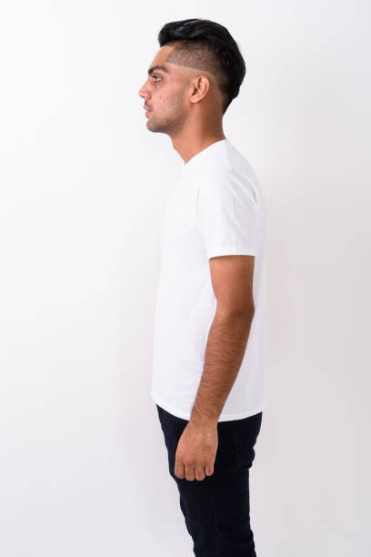 istock Profile view of young Indian man standing against white background 672153420