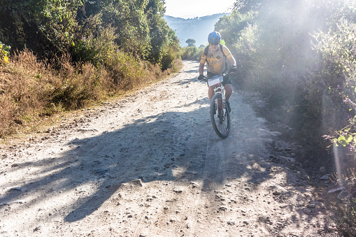 Jalapa: Man, is riding bicycle on the dirt road in the mountains near Jalapa in Guatemala.