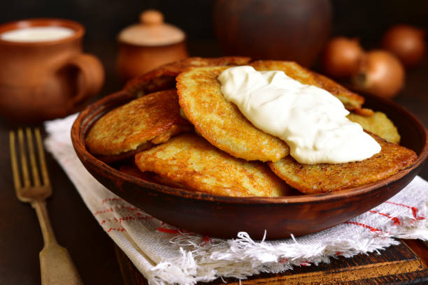 Draniki - potato pancakes stuffed with minced meat Draniki - potato pancakes stuffed with minced meat,traditional dish of east slavic cuisine on a ruatic background. lithuania stock pictures, royalty-free photos & images