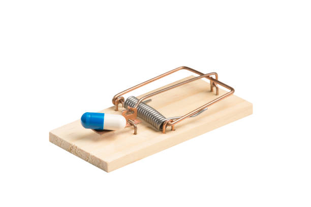 istock Drug Capsule in a Mousetrap 672169032