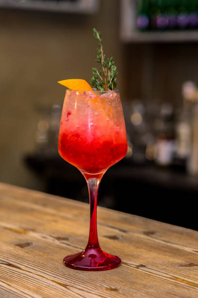 istock Red cocktail on the wood plate 672185156