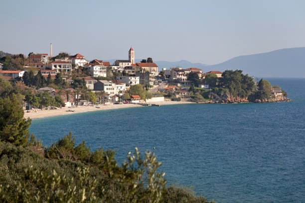 istock Sand beach under houses and Church 672185254