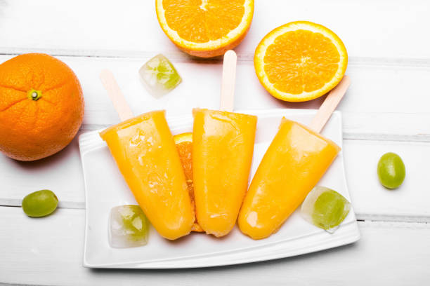 istock Homemade orange ice cream on a stick 672188146