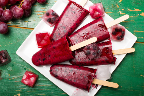 istock Homemade blueberry and grape ice cream on a stick 672189356