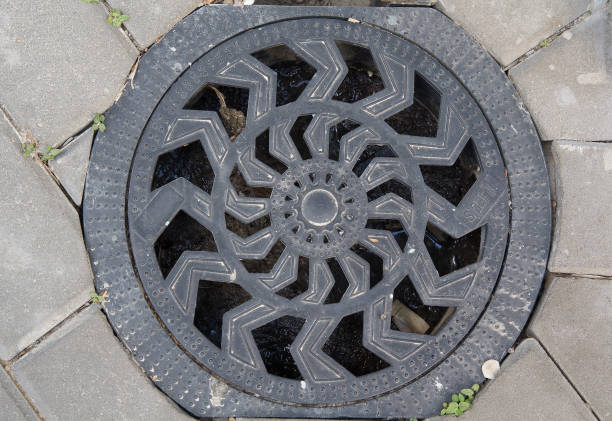 istock Metal hatch on the stone pavement. Architecture 672191962