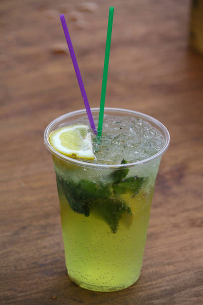 istock Fresh cocktail with soda, lime on a wooden background. 672192458