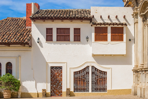 Street view at the facade of white houses in the historic district of Granada in Nicaragua