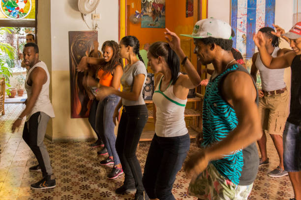 Enjoying the dance class at Havana, Cuba. A group of cuban young people are enjoying a dance class at the dance school at Havana, Cuba. They are learning to dance "salsa", a typical cuban music. The city of Havana is an Unesco World Heritage Site. salsa music photos stock pictures, royalty-free photos & images