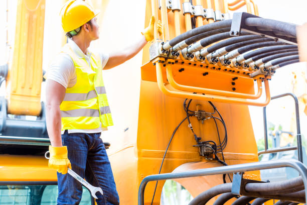 istock Asian mechanic at machine maintenance 672210400