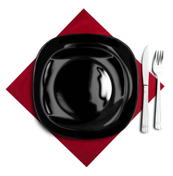 istock Black plate, fork and knife on red napkin 672211002