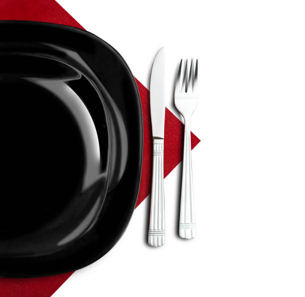 istock Black plate, fork and knife on red napkin 672211008