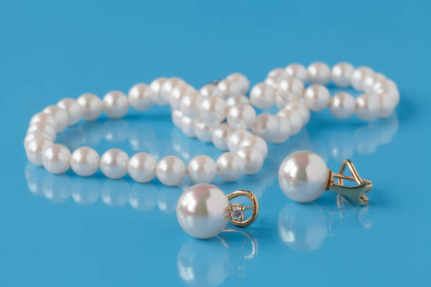 istock Strings of pearl on blue background 672217000