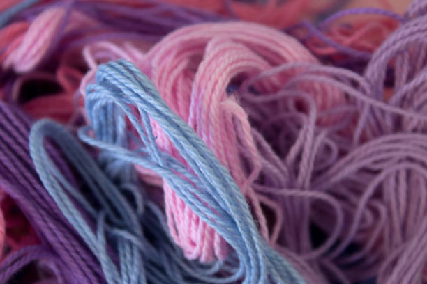 istock Pastel Pink,Purple and Blue Cotton Embroidery threads background 672217318