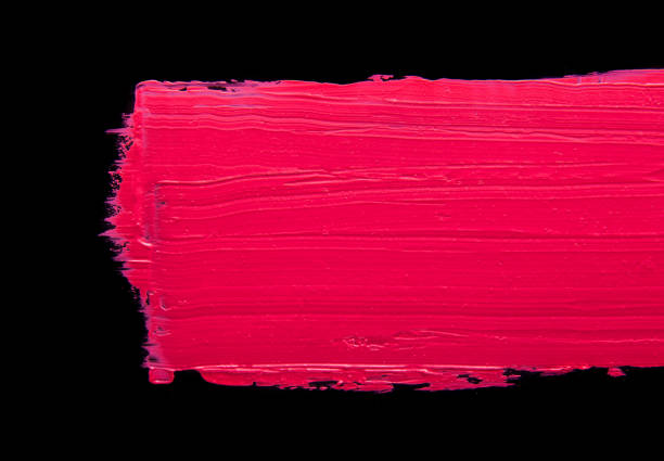 istock Smudged lipstick pink on a black isolated background 672220570