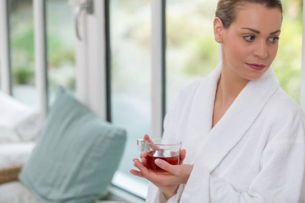 istock beautiful woman drinking tea in relaxation room 672223086