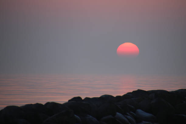 The sun disappears into the sea in February