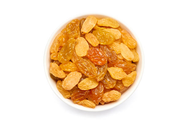 istock Bowl of golden raisins on white 672233100
