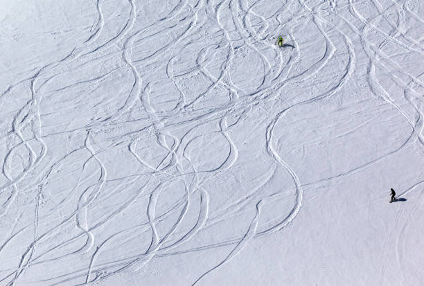 istock Snowboarders and skiers on off piste slope 672236700