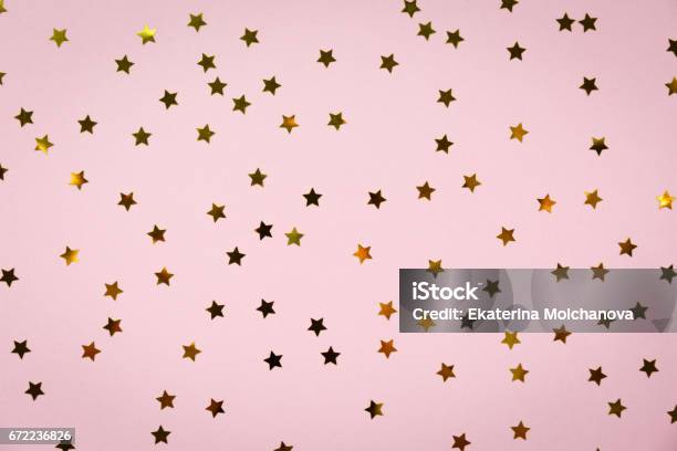 Golden Star Sprinkles On Pink Festive Holiday Background Celebration Concept Stock Photo - Download Image Now