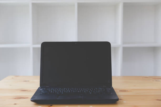 istock laptop computer with blank white screen on wood desk 672237226