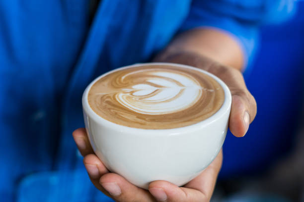 istock coffee latte art in hand barista 672247432