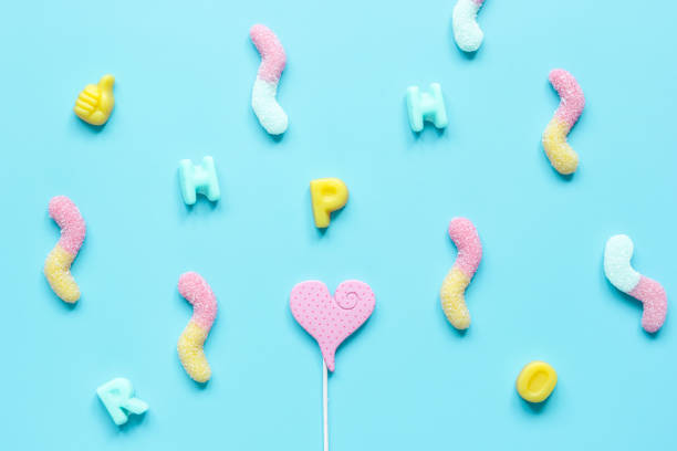 istock Closeup of candy on blue table background top view pattern 672251200