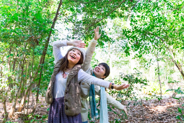 istock Two young women laughing at the park 672262874