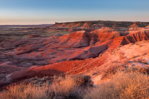 istock Sunlit red hills of Painted Desert at sunset 672265716
