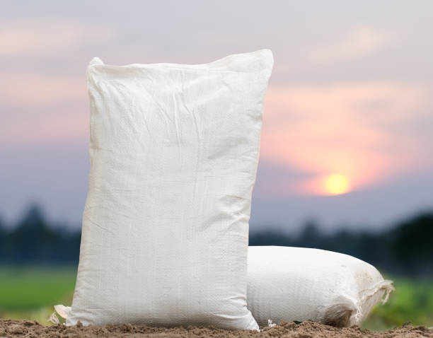 Fertilizer bag over sunrise stock photo