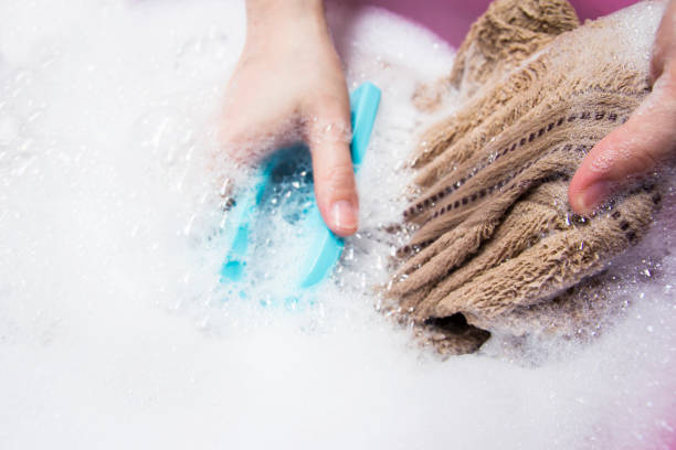 istock Woman washing towel 672278728