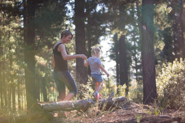 istock Mother and daughter playing joyfully in the forest 672284506