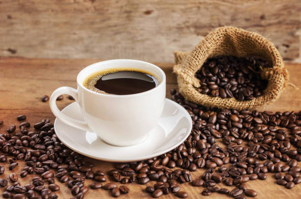 istock coffee cup and coffee bean in bag sack on wood background 672285040