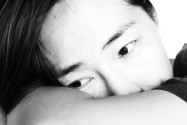 istock sadness woman leaning on chair 672287394