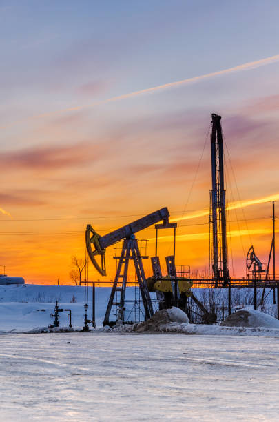 istock Pump jack, wellhead and oil rig during sunset 672287544