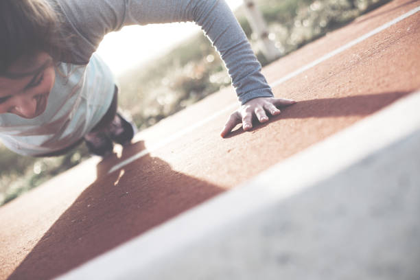 istock Woman athlete doing push-ups exercise outdoors 672304926