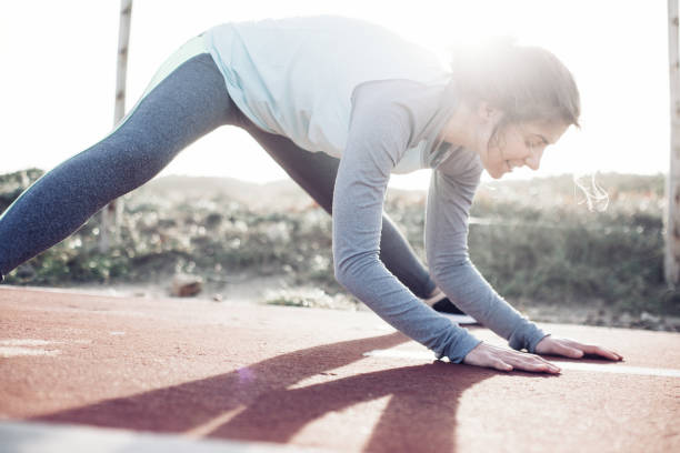 istock Woman athlete doing legs stretching exercise outdoors 672306158
