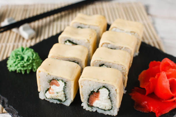 istock Sushi rolls with cream cheese and salmon close up 672308254